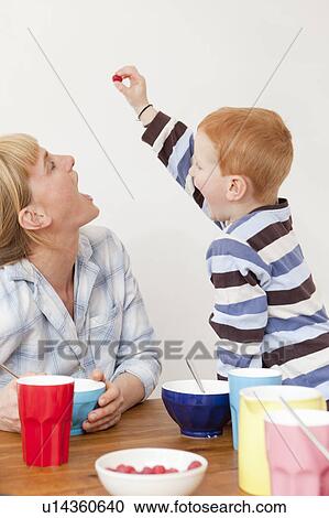Mother and son playing at table View Large Photo Image Stock Image - Mother and son playing at table. Fotosearch