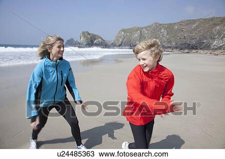 Mother and son playing on beach View Large Photo Image Stock Image - Mother and son playing on beach. Fotosearch