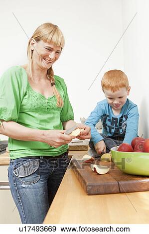 Mother and son slicing apples together View Large Photo Image Stock Photo - Mother and son slicing apples together. Fotosearch