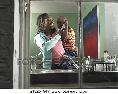 Mother and son talking on phone together View Large Photo Image Stock Photo - Mother and son talking on phone together. Fotosearch