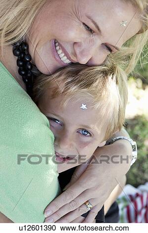 Mother embracing son outdoors View Large Photo Image Stock Image - Mother embracing son outdoors. Fotosearch
