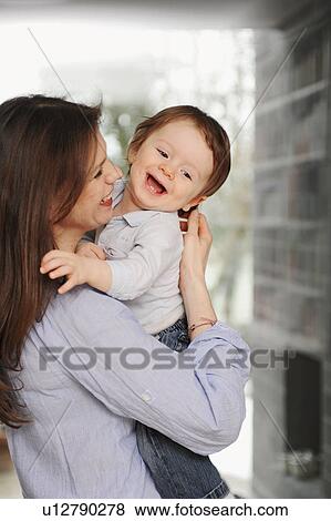 Mother holding toddler son View Large Photo Image Stock Photo - Mother holding toddler son. Fotosearch