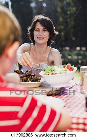 Mother serving salad at picnic View Large Photo Image Stock Photograph - Mother serving salad at picnic. Fotosearch
