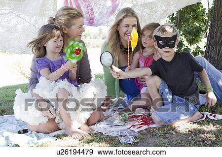 Stock Photo - Mothers and children playing in backyard. Fotosearch