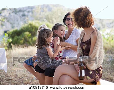 Stock Photography - Mothers and children playing outdoors. Fotosearch