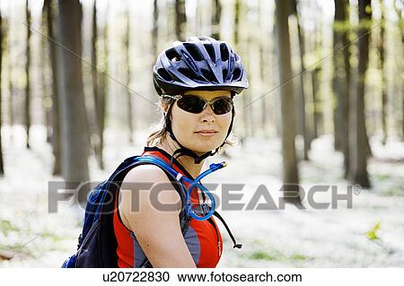 Mountain biker standing in forest View Large Photo Image Stock Image - Mountain biker standing in forest. Fotosearch