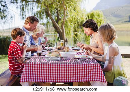 Stock Photo - Multi generation family having a picnic. Fotosearch