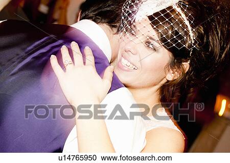 Stock Image - Newlywed couple dancing at reception. Fotosearch