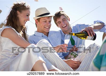 Newlywed couple drinking champagne View Large Photo Image Stock Photo - Newlywed couple drinking champagne. Fotosearch