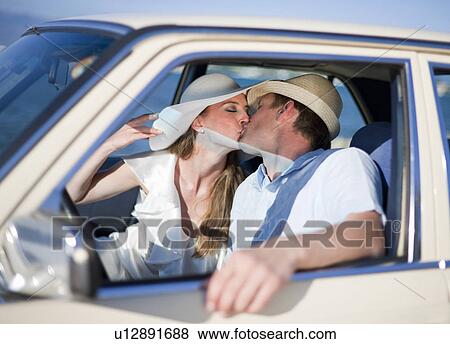 Newlywed couple kissing in car View Large Photo Image Stock Photo - Newlywed couple kissing in car. Fotosearch