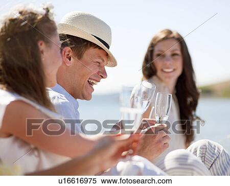 Newlywed couple laughing with friends View Large Photo Image Stock Photography - Newlywed couple laughing with friends. Fotosearch
