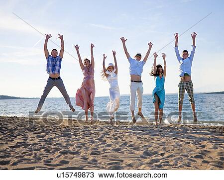 Newlywed couple on beach with friends View Large Photo Image Stock Image - Newlywed couple on beach with friends. Fotosearch