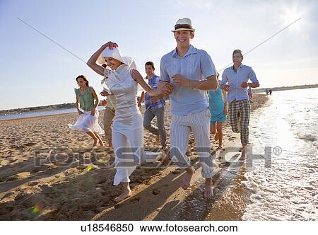 Newlywed couple on beach with friends View Large Photo Image Stock Image - Newlywed couple on beach with friends. Fotosearch