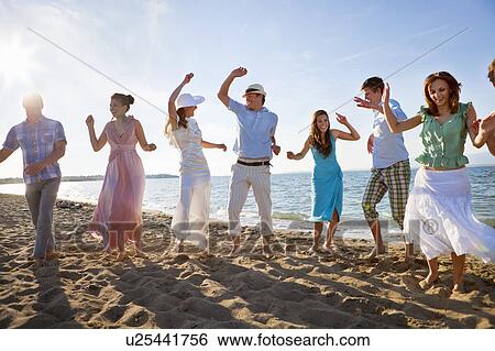 Newlywed couple on beach with friends View Large Photo Image Stock Photograph - Newlywed couple on beach with friends. Fotosearch