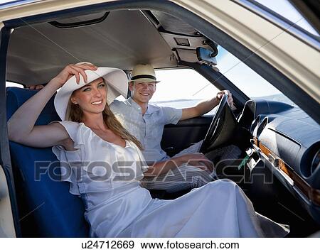 Newlywed couple riding in car View Large Photo Image Stock Photo - Newlywed couple riding in car. Fotosearch