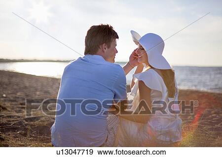 Newlywed couple sitting on beach View Large Photo Image Stock Photo - Newlywed couple sitting on beach. Fotosearch