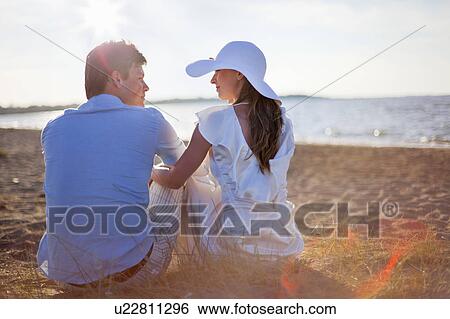Newlywed couple sitting on beach View Large Photo Image Stock Photograph - Newlywed couple sitting on beach. Fotosearch