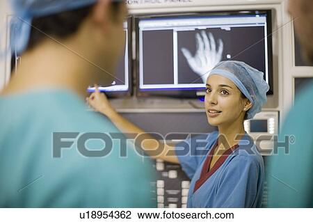 Nurse examining x-ray of hand View Large Photo Image Stock Image - Nurse examining x-ray of hand. Fotosearch