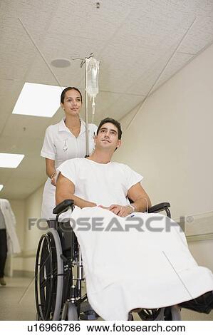 Nurse pushing patient in wheelchair View Large Photo Image Stock Photograph - Nurse pushing patient in wheelchair. Fotosearch