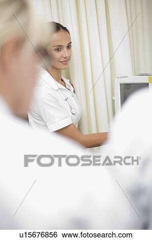 Stock Photograph - Nurse using equipment in hospital. Fotosearch