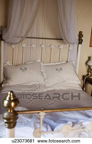 Stock Image - Old-fashioned bed with curtains. Fotosearch