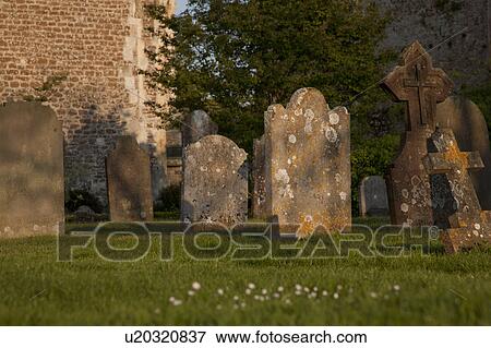 Stock Photo - Old headstones in church graveyard. Fotosearch