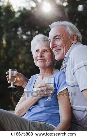 Older couple drinking wine outdoors View Large Photo Image Stock Photo - Older couple drinking wine outdoors. Fotosearch
