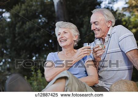 Stock Photography - Older couple drinking wine outdoors. Fotosearch