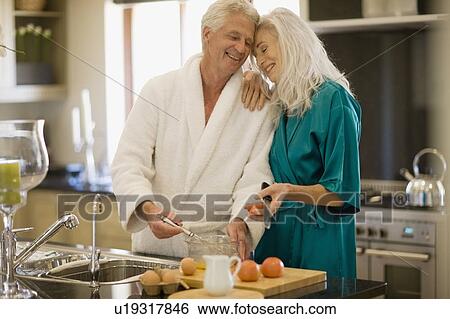 Older couple in bathrobes cooking View Large Photo Image Stock Photograph - Older couple in bathrobes cooking. Fotosearch