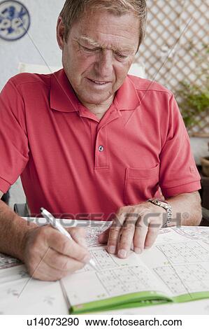 Older man completing sudoku puzzle View Large Photo Image Stock Image - Older man completing sudoku puzzle. Fotosearch
