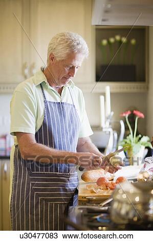 Older man cooking in kitchen View Large Photo Image Stock Image - Older man cooking in kitchen. Fotosearch