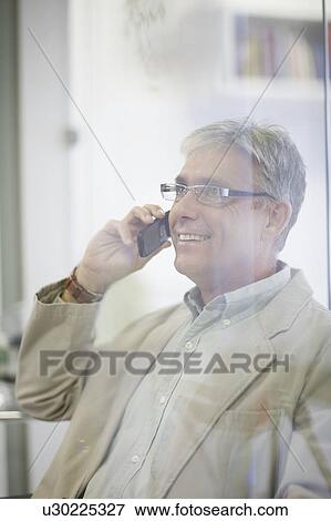 Older man talking on cell phone View Large Photo Image Stock Photo - Older man talking on cell phone. Fotosearch