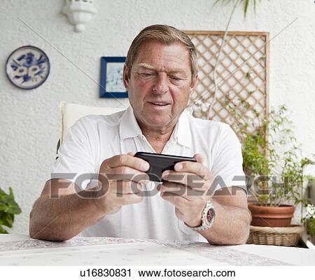 Older man using cell phone View Large Photo Image Stock Image - Older man using cell phone. Fotosearch