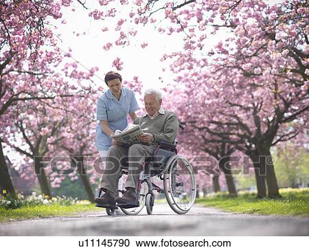 Older man with caretaker in park View Large Photo Image Stock Image - Older man with caretaker in park. Fotosearch