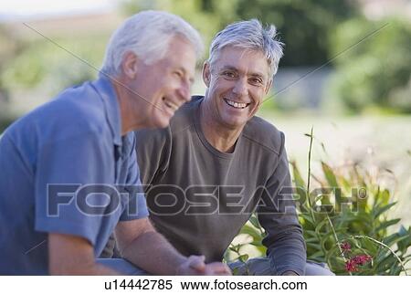 Stock Photography - Older men smiling in garden. Fotosearch