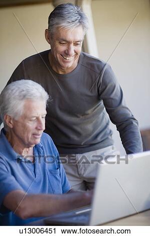 Older men using laptop together View Large Photo Image Stock Image - Older men using laptop together. Fotosearch
