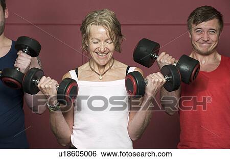 Older people lifting weights in gym View Large Photo Image Stock Photograph - Older people lifting weights in gym. Fotosearch