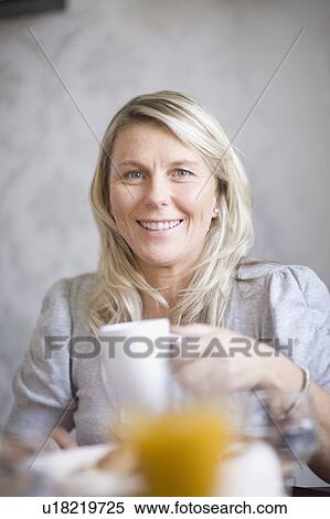 Older woman drinking coffee at breakfast View Large Photo Image Stock Photography - Older woman drinking coffee at breakfast. Fotosearch