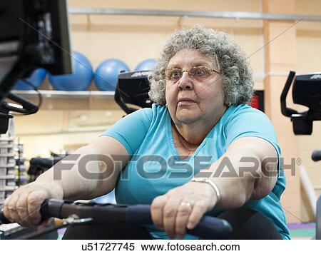 Older woman using rowing machine View Large Photo Image Stock Photography - Older woman using rowing machine. Fotosearch