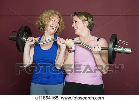 Older women lifting weights in gym View Large Photo Image Stock Photography - Older women lifting weights in gym. Fotosearch