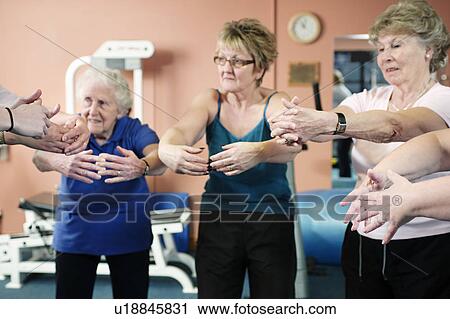 Older women stretching in gym View Large Photo Image Stock Image - Older women stretching in gym. Fotosearch