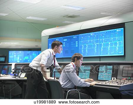 Stock Photo - Operators in power station control room. Fotosearch