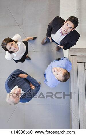 Stock Image - Overhead view of business people talking. Fotosearch
