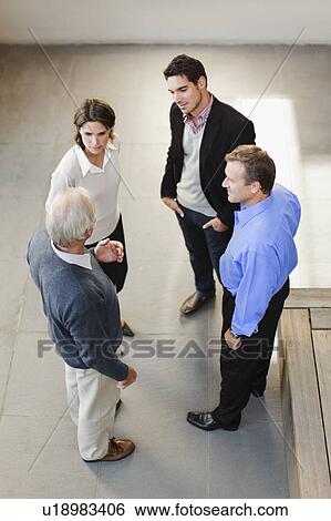 Overhead view of business people talking View Large Photo Image Stock Photograph - Overhead view of business people talking. Fotosearch