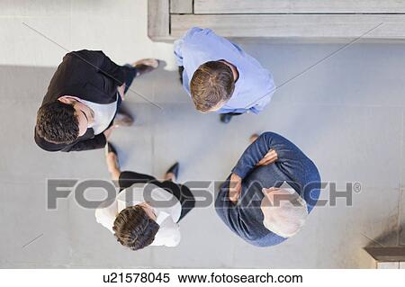 Stock Photography - Overhead view of business people talking. Fotosearch