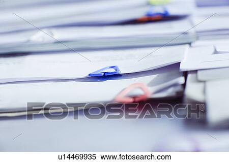 Stock Photography - Paper clips on documents in office. Fotosearch