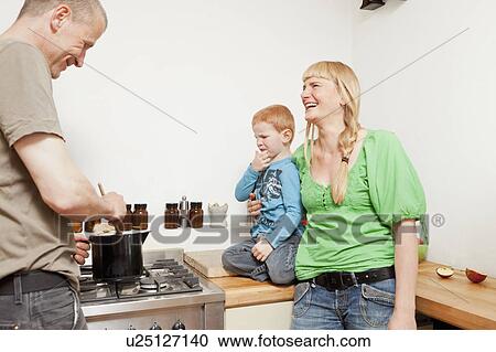Parents cooking for reluctant son View Large Photo Image Stock Image - Parents cooking for reluctant son. Fotosearch