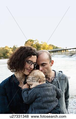 Parents holding sleeping baby View Large Photo Image Stock Photo - Parents holding sleeping baby. Fotosearch