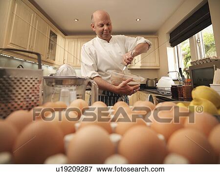 Stock Photo - Pastry chef baking at home. Fotosearch