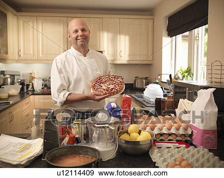 Pastry chef baking cake at home View Large Photo Image Stock Photo - Pastry chef baking cake at home. Fotosearch